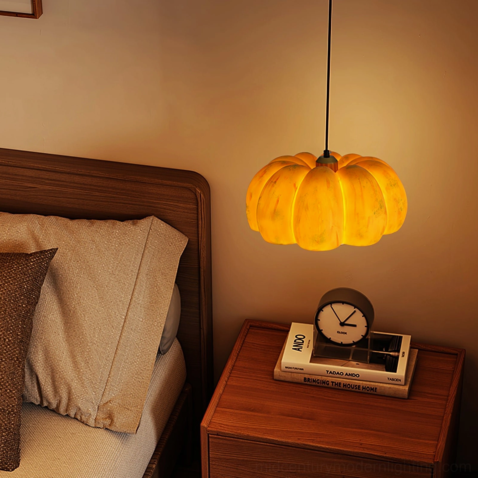 Pumpkin pendant lamp warm orange tone hanging beside wooden bedroom furniture and bedside table