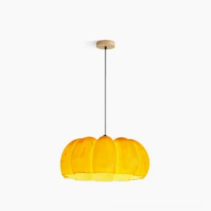 Pumpkin pendant lamp with warm amber ribbed glass shade and brass hardware, front studio view