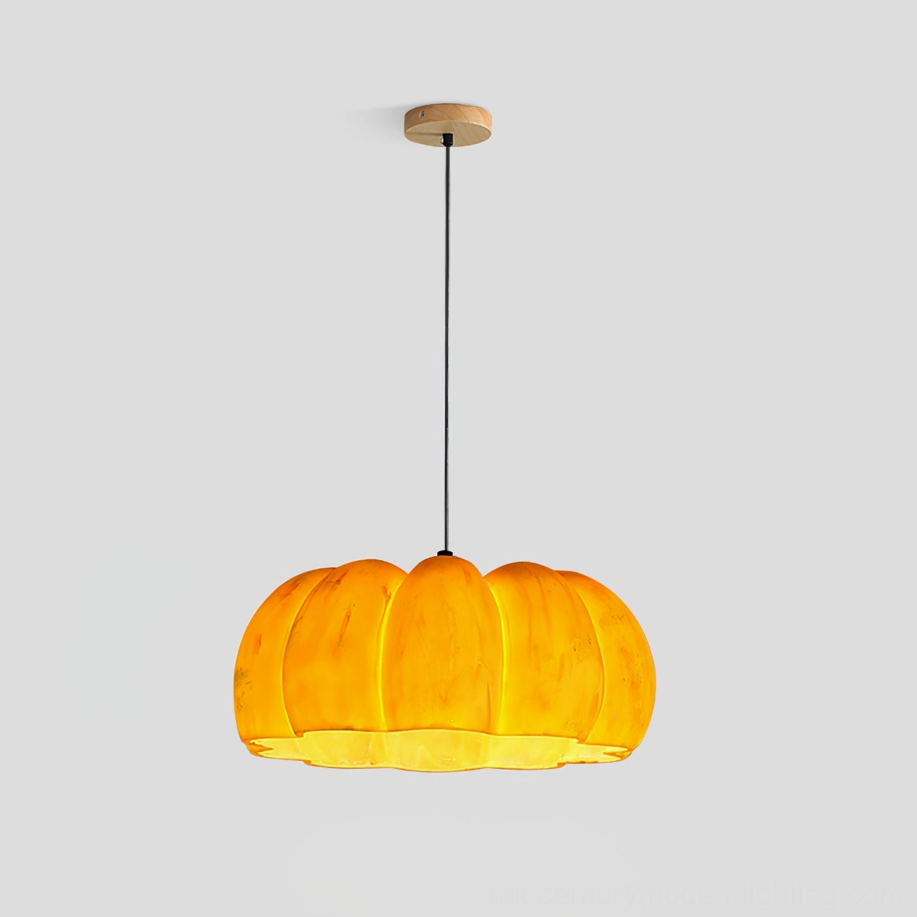Large pumpkin pendant lamp showing full size scale and warm amber glass shade quality