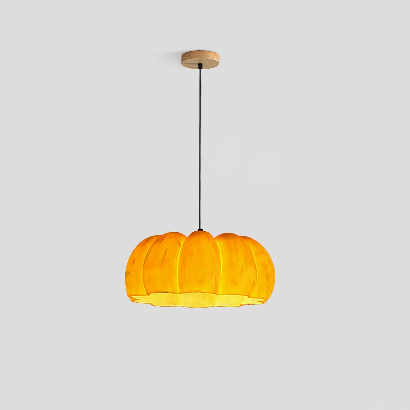 Pumpkin pendant lamp medium size with warm amber color and brass top accent detail