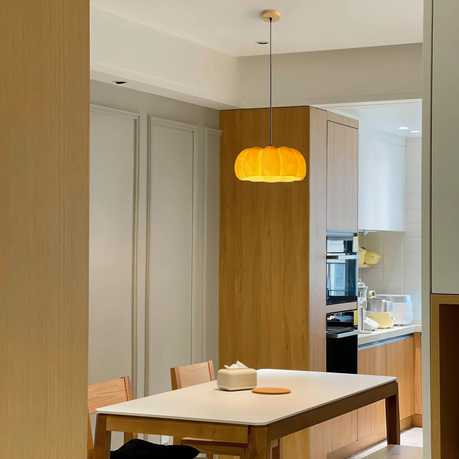 Medium size pumpkin pendant lamp creating warm ambient lighting in contemporary home interior