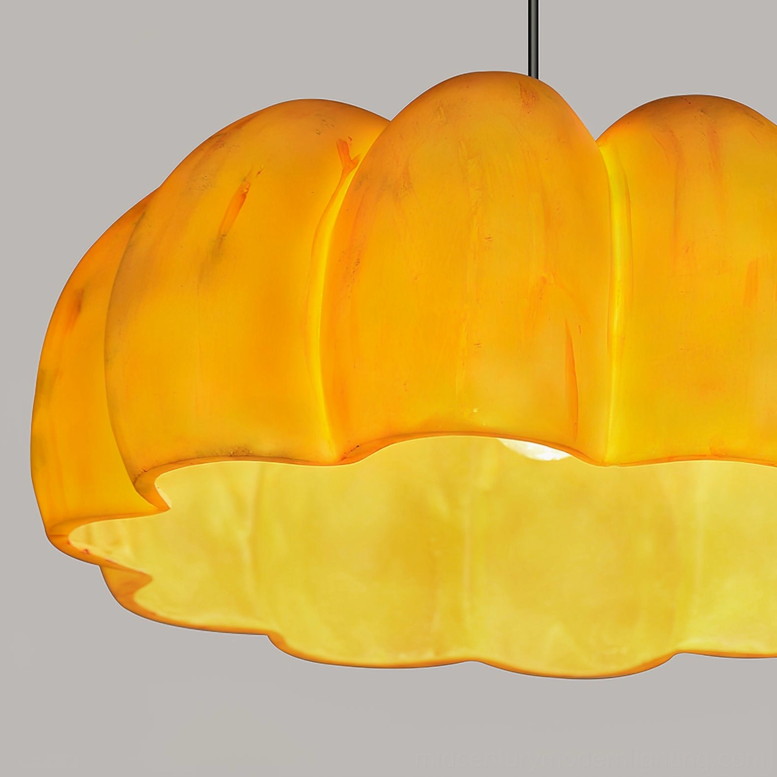 Pumpkin pendant lamp multiple angle view showcasing warm amber glass and brass hardware finish
