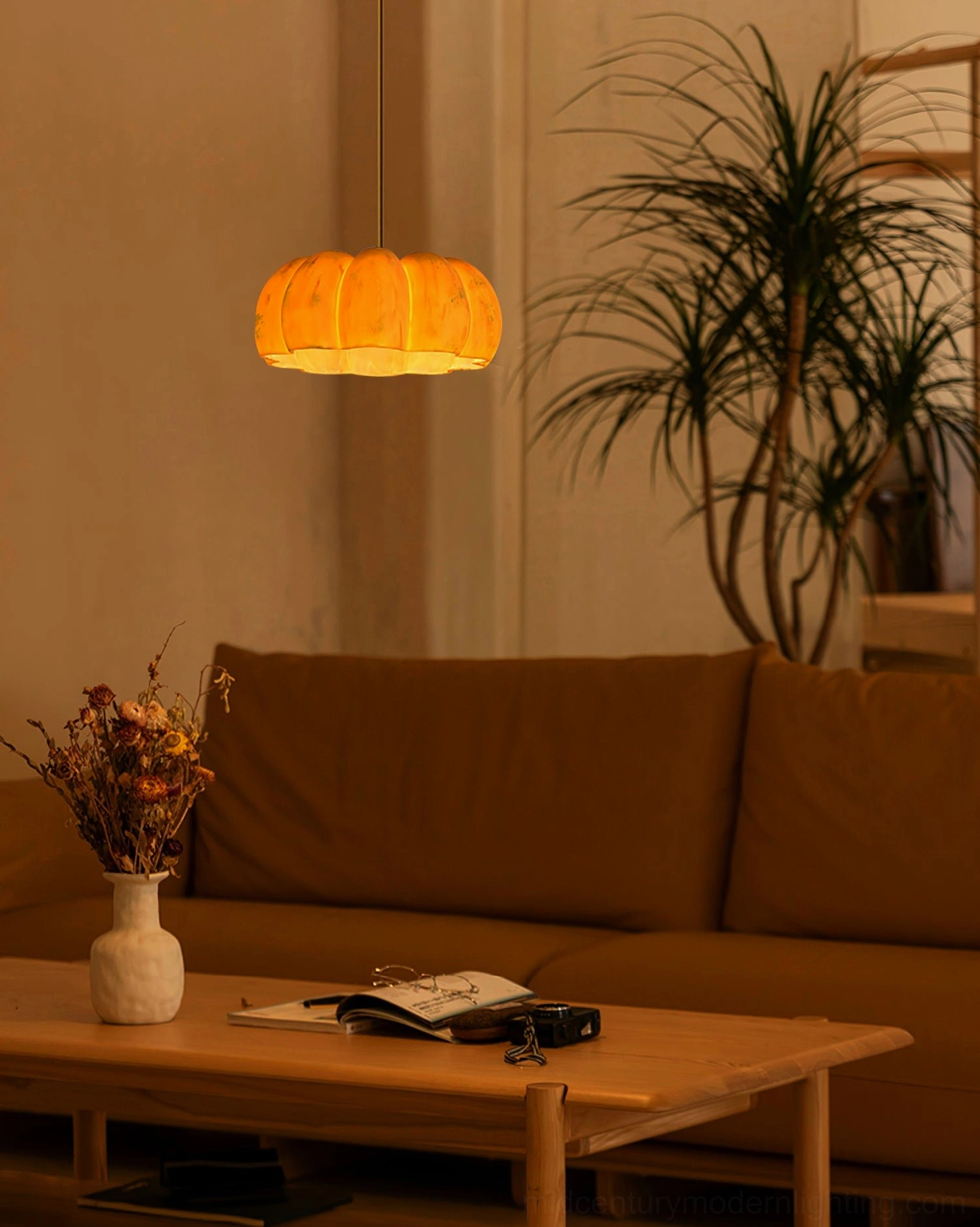 Pumpkin pendant lamp displaying warm amber glow and organic biomorphic silhouette design