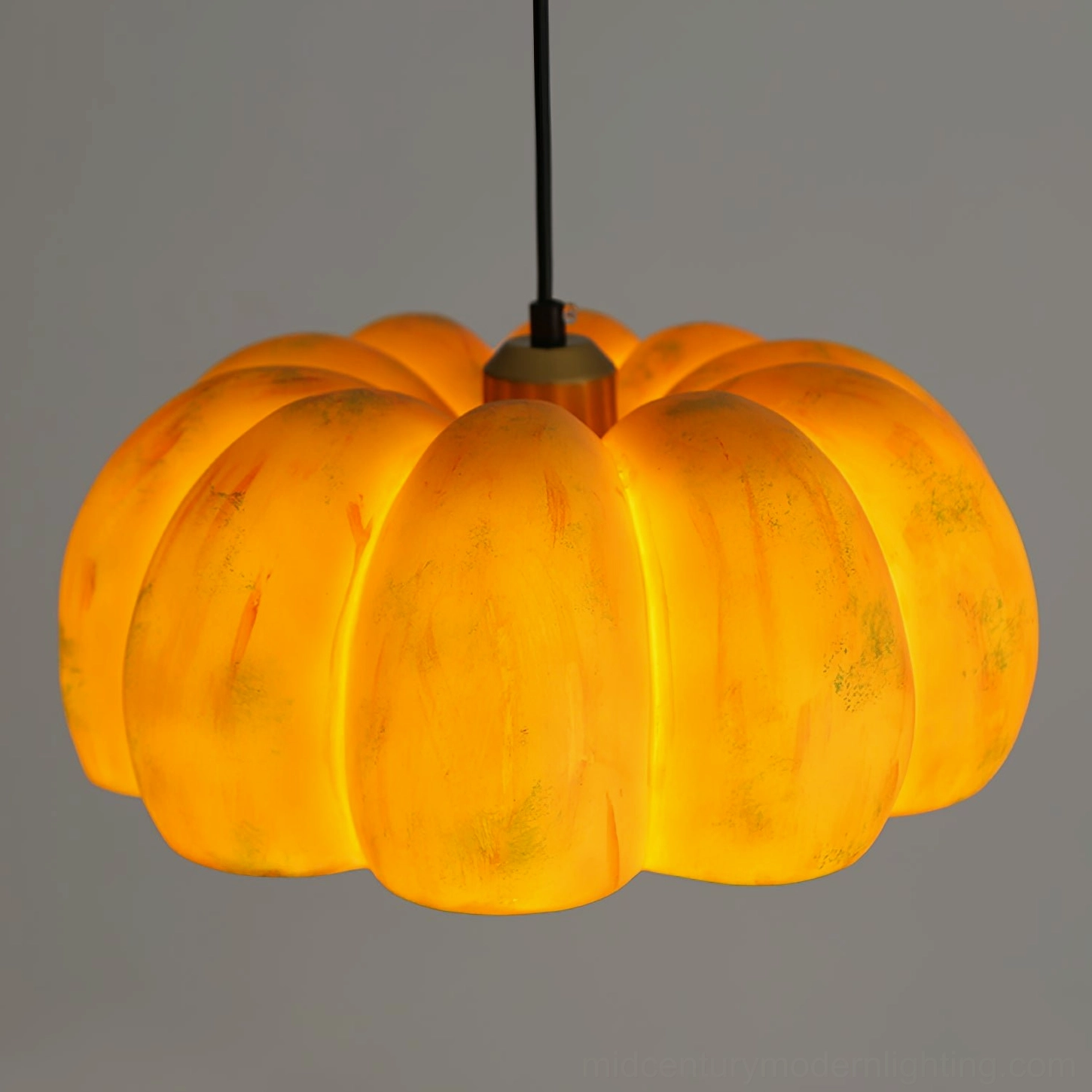 Dual pumpkin pendant lamps creating warm ambient lighting in modern dining room with neutral decor