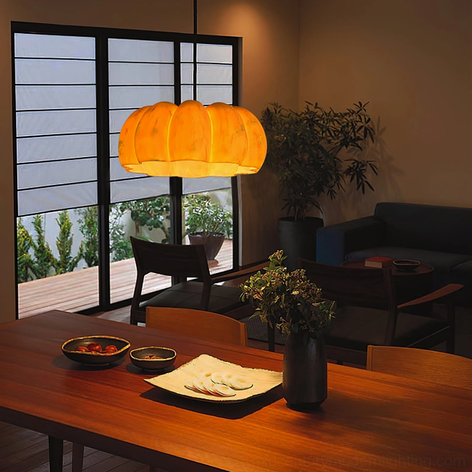 Pumpkin pendant light fixture with distinctive ribbed gourd shape in warm amber glass