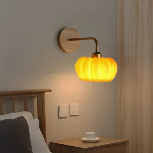 Pumpkin wall sconce mounted in bedroom beside nightstand, creating warm ambient light in Japanese-inspired minimalist bedroom decor