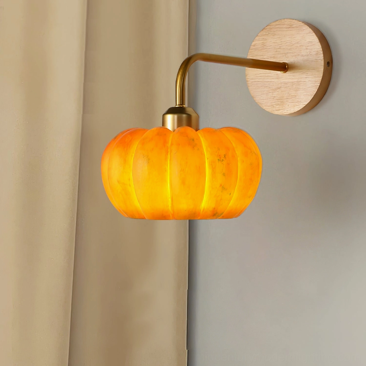 Close-up side view of pumpkin wall lamp showing fixture structure, metal frame details, and amber glass composition