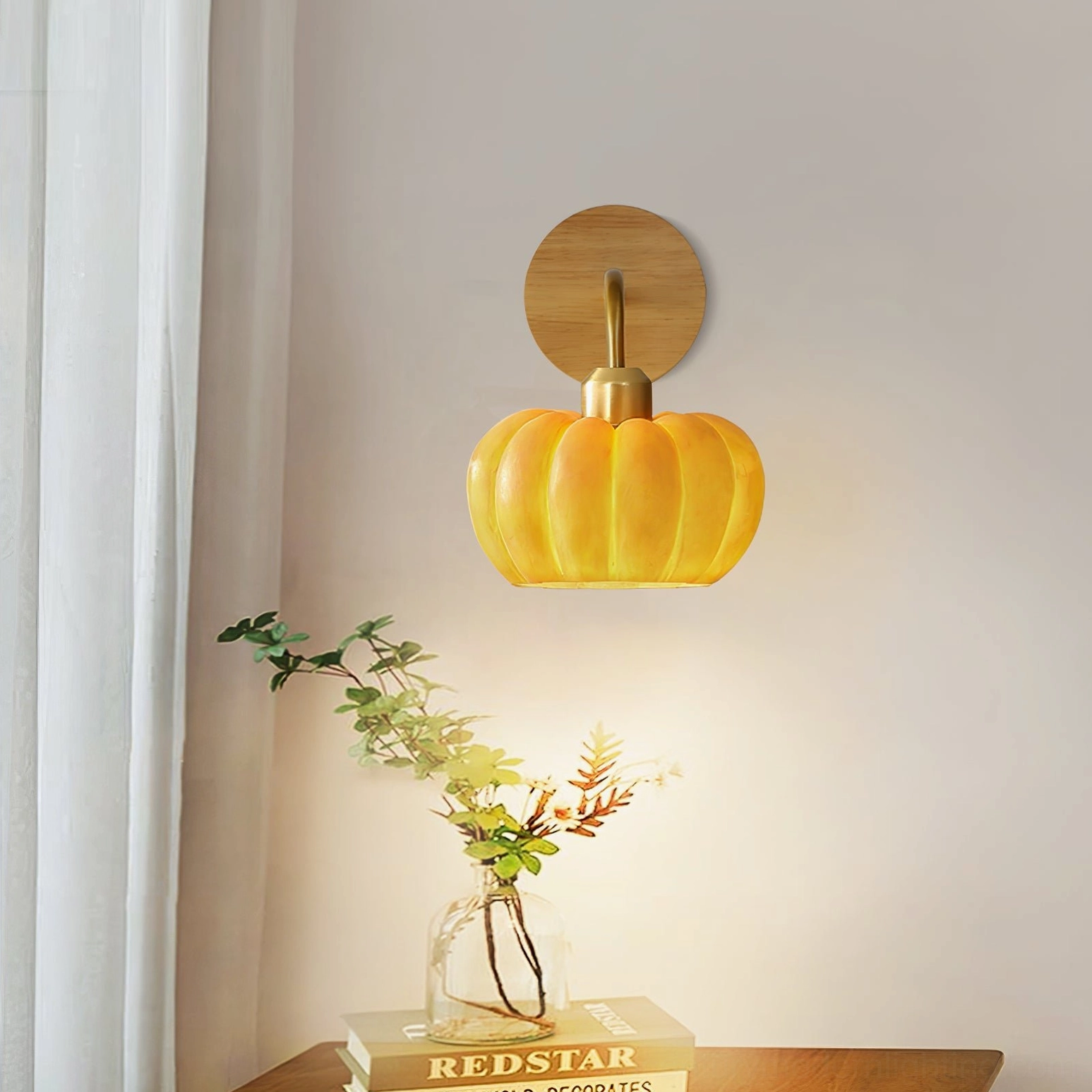 Pumpkin wall fixture on wooden side table with glass vase and plant decor, low-angle view showing organic design form