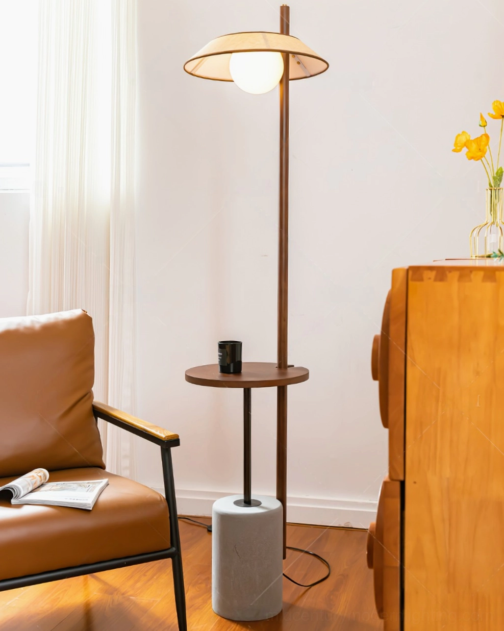 Puro floor lamp illuminated in sunlit living room with leather armchair and natural daylight