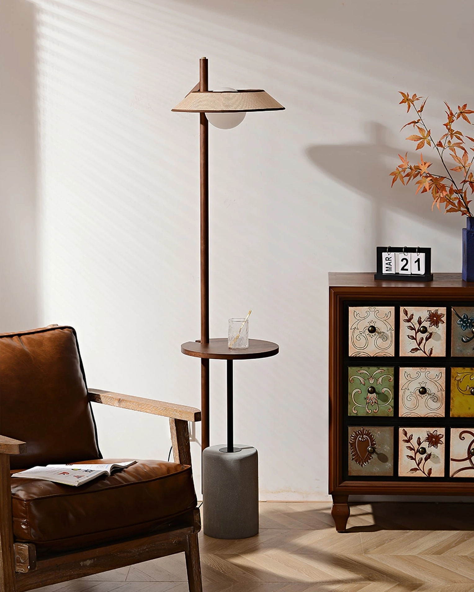 Puro floor lamp in bohemian living room with patterned cabinet, dried flowers, and clock
