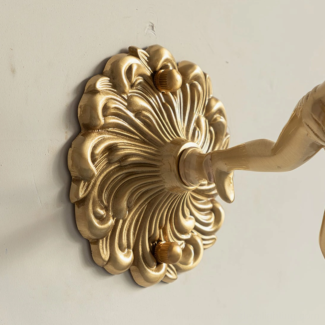 Illuminated putti cherub wall sconce creating warm ambient lighting effect, frosted white glass petal shade with subtle yellow detailing and brass angel