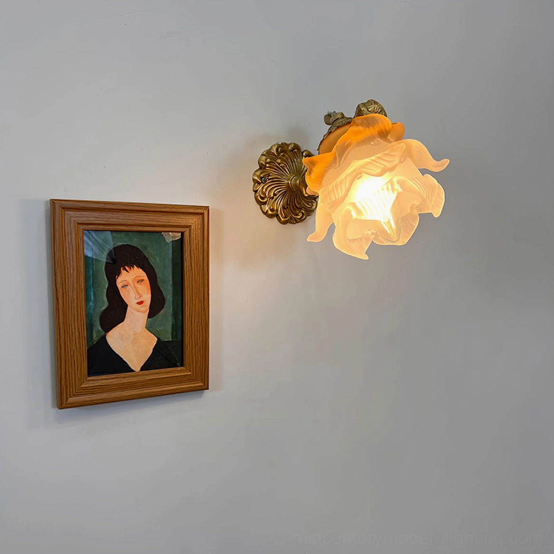 Putti cherub wall lamp mounted beside interior window with louver blinds, warm frosted glass shade, brass angel decor in vintage home setting