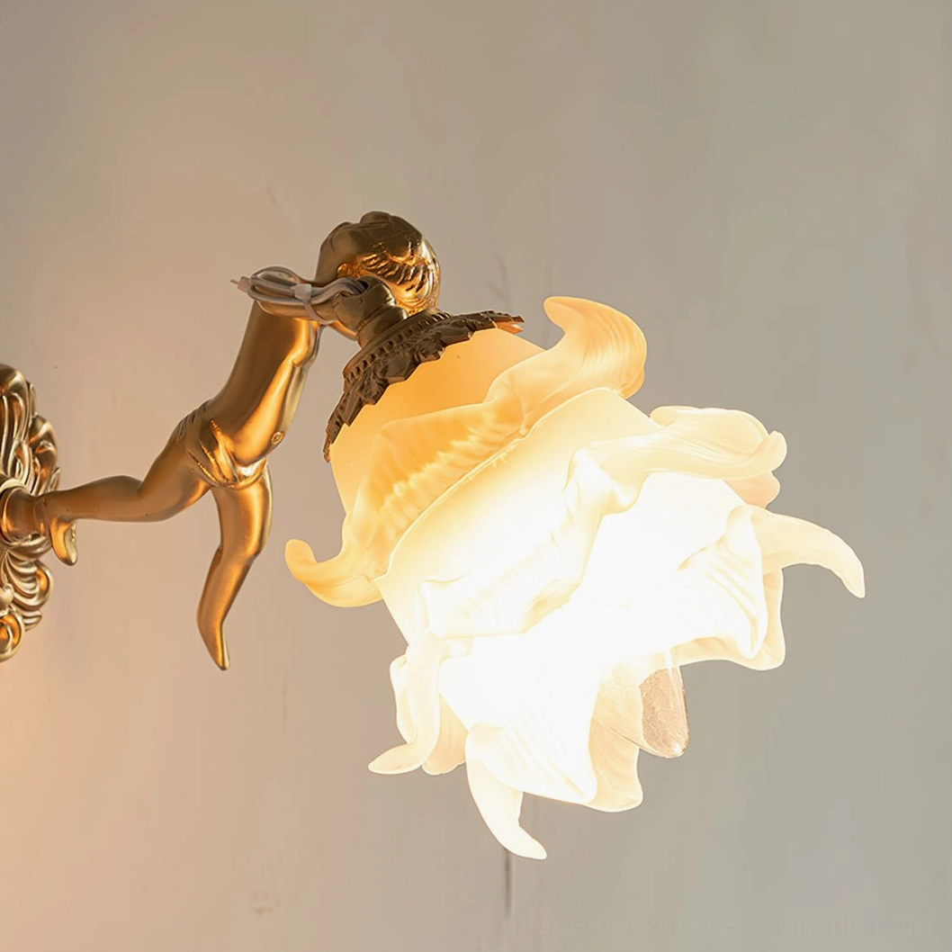 Putti cherub wall sconce detail shot from low angle, highlighting textured frosted glass petals and modeled brass angel figure with ornate mounting