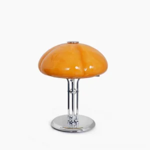 Quadrifoglio four-leaf clover table lamp with warm amber-orange hand-shaped glass shade and polished chrome base, studio lighting