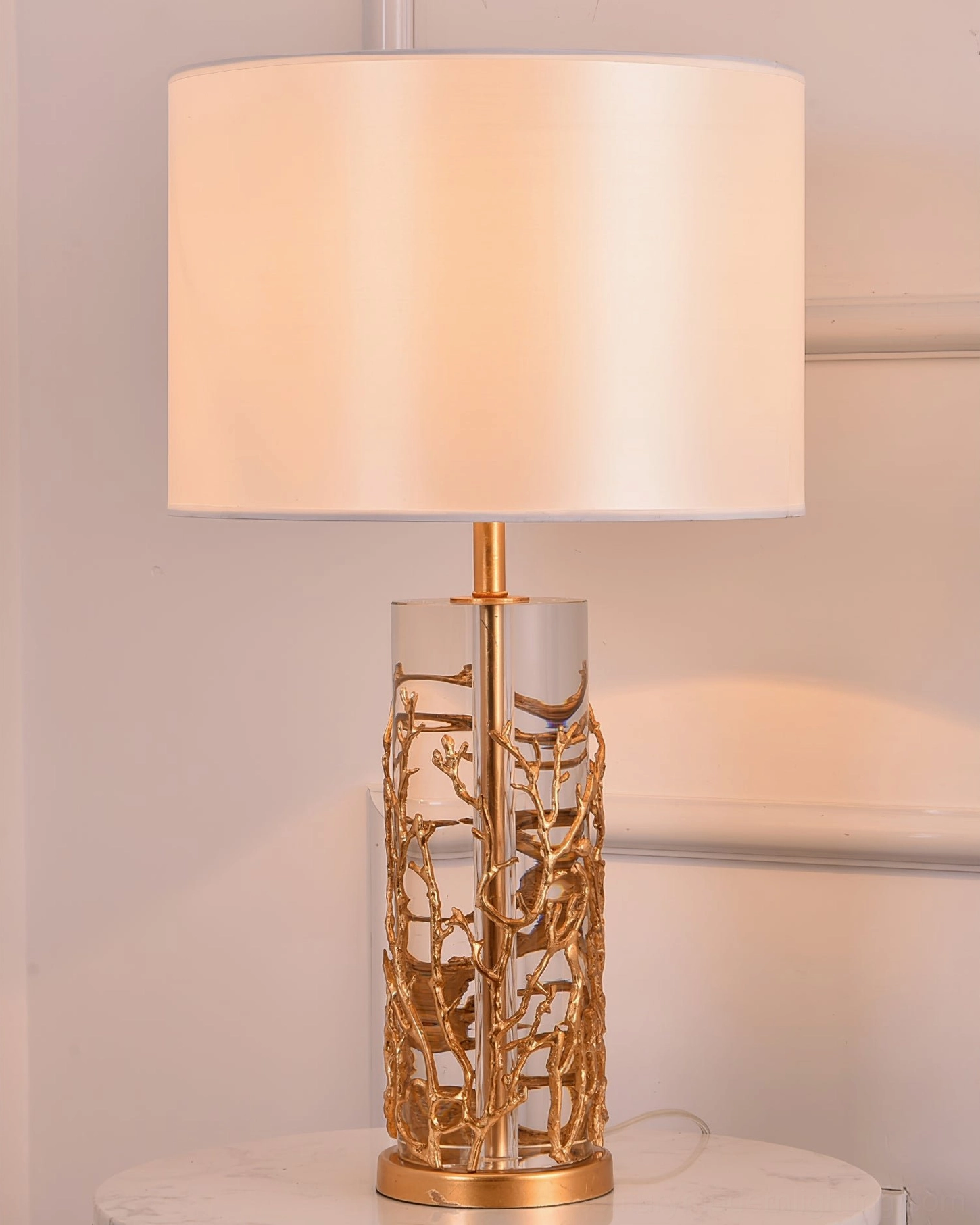 Quatrefoil table lamp with light pink shade on marble side table elegant minimalist style