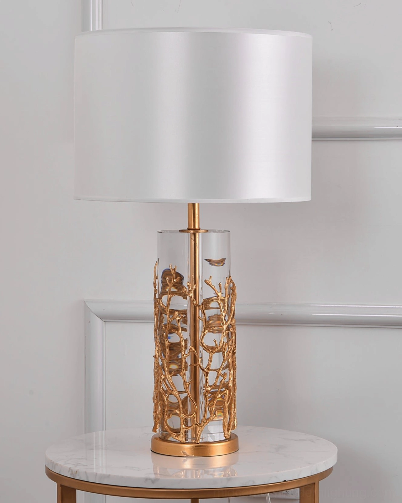 Quatrefoil table lamp with white shade on side table white wall home decor modern style