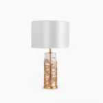 Quatrefoil crystal table lamp with white drum shade and brass carved glass base, front studio view