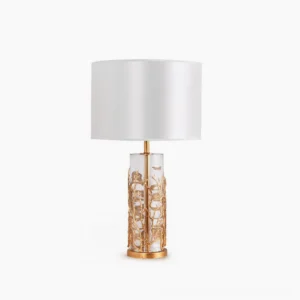 Quatrefoil crystal table lamp with white drum shade and brass carved glass base, front studio view