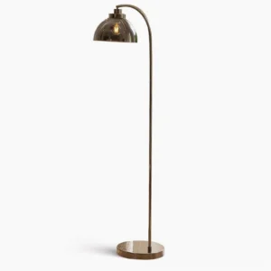 Radcliff arc floor lamp with polished nickel finish and smoked glass dome shade in minimalist studio setting
