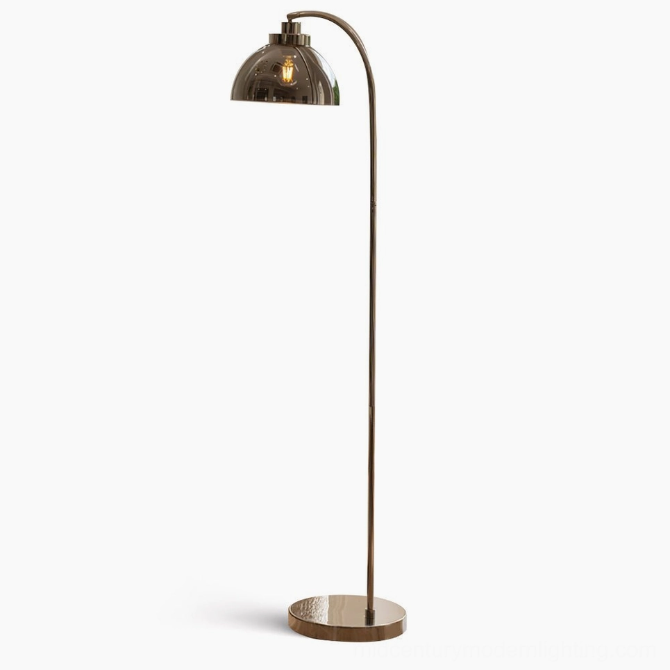 Radcliff arc floor lamp with polished nickel finish and smoked glass dome shade in minimalist studio setting