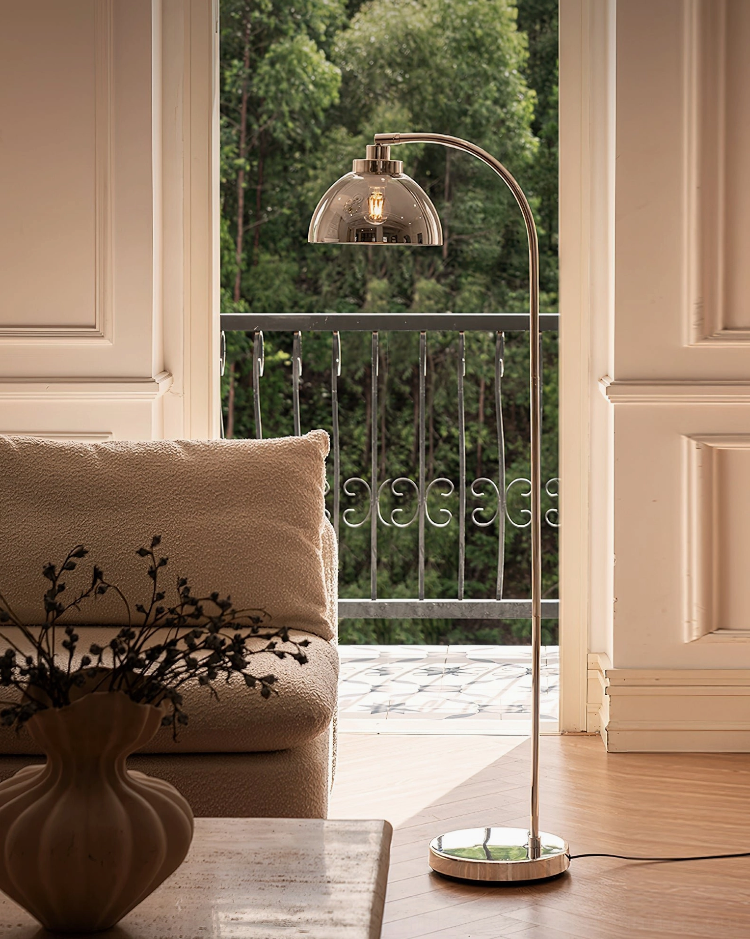 Arc floor lamp architectural detail showing polished metal finish and curved silhouette