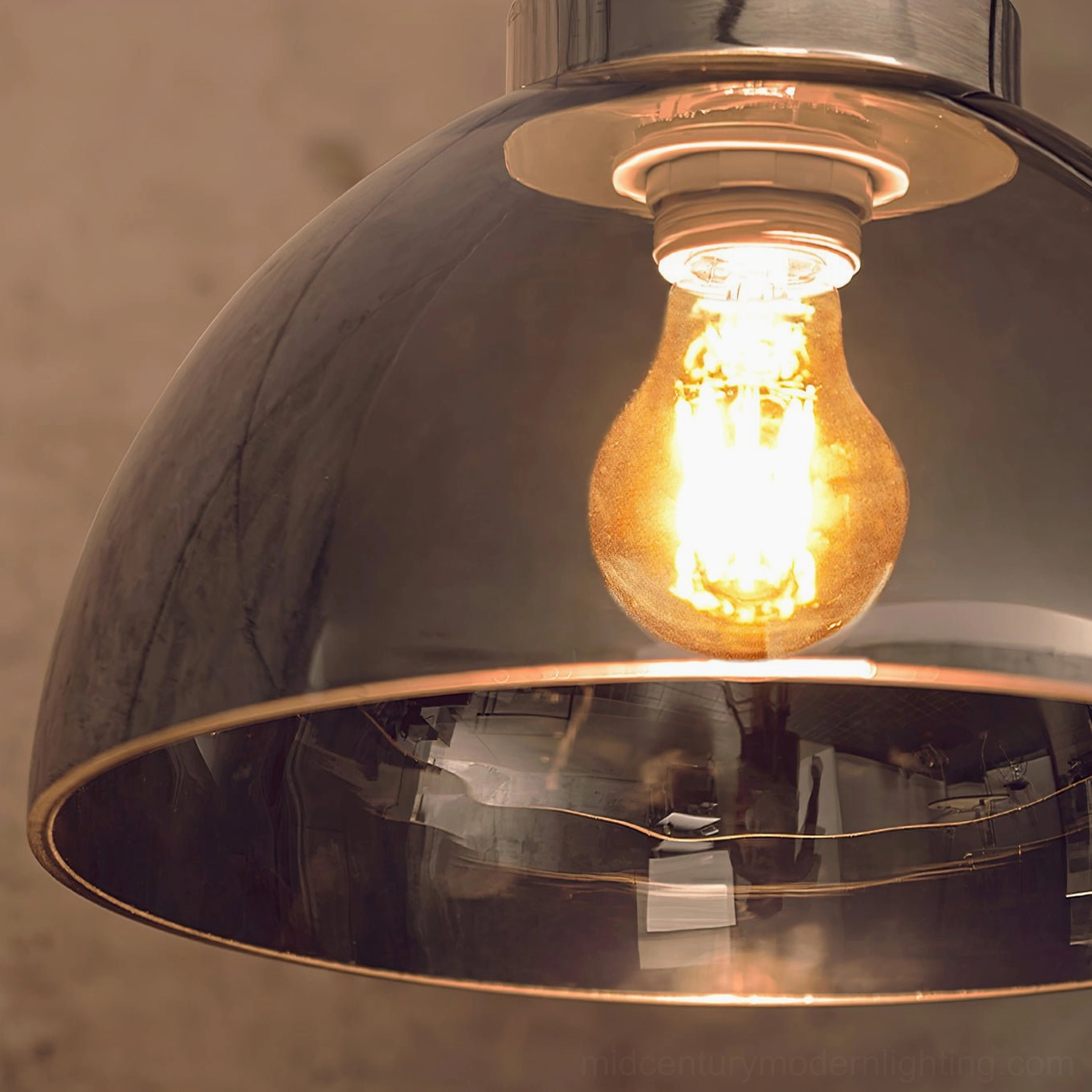 Close-up of Radcliff lamp shade showing reflective metal interior and exposed vintage Edison bulb