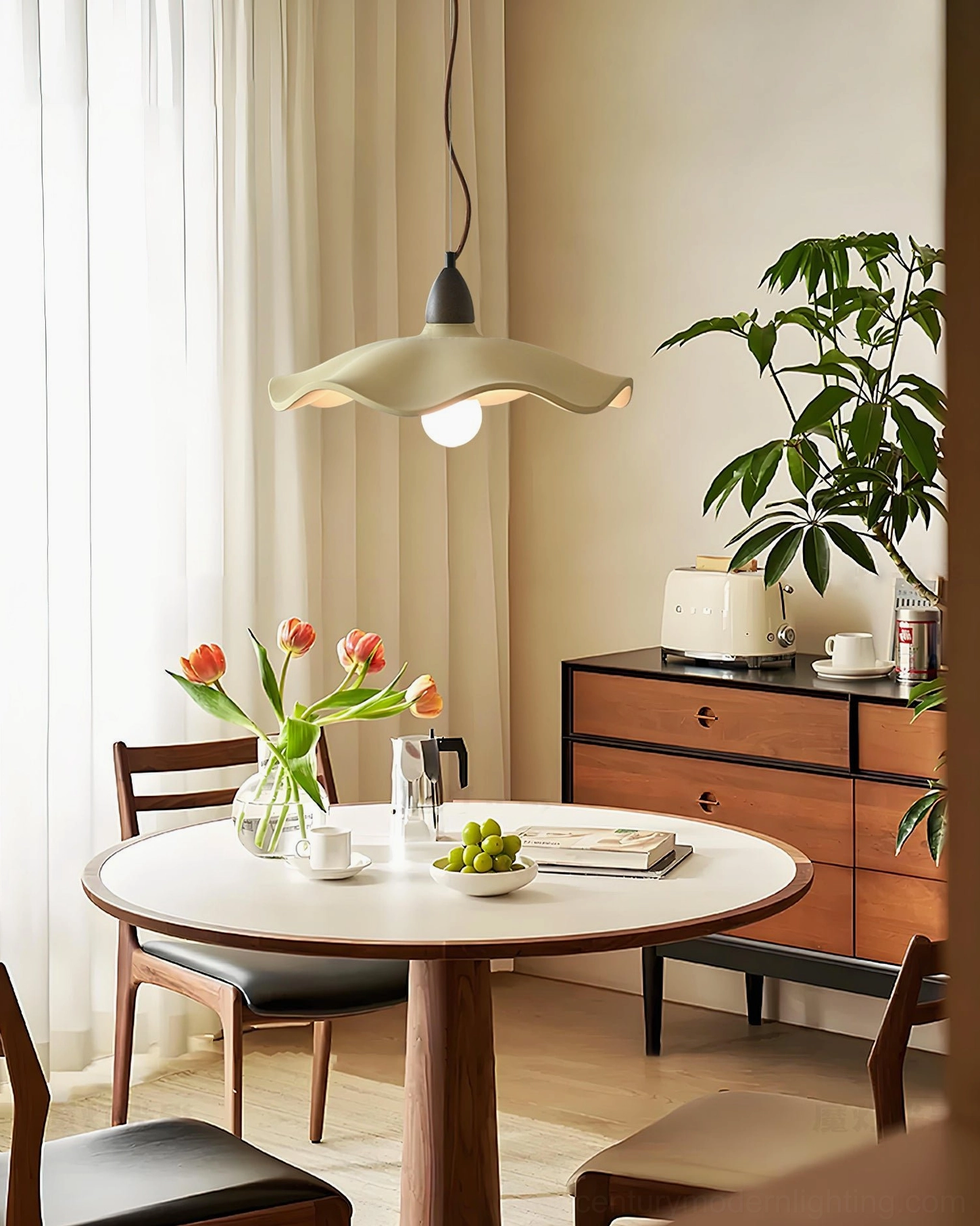Radha wave pendant suspended above warm wooden dining table in Nordic dining room setting