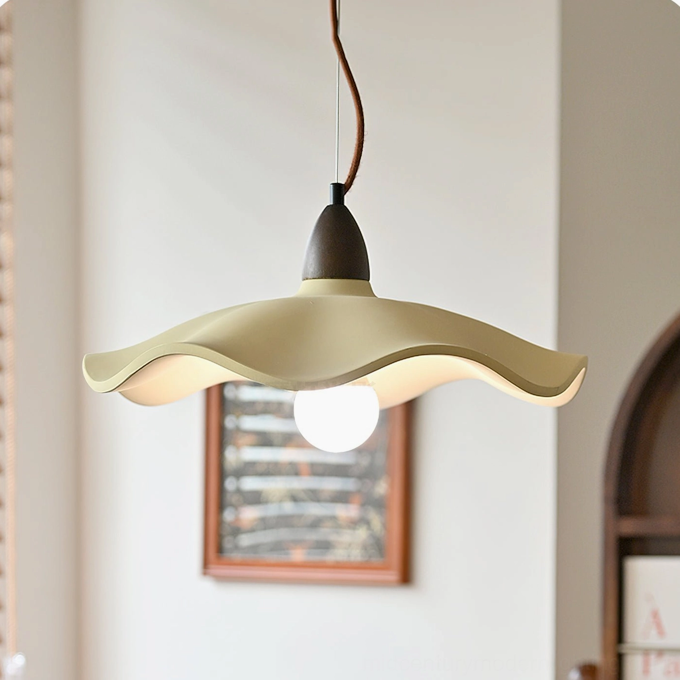 Radha pendant with exposed warm glow bulb and matte beige shade in contemporary indoor space