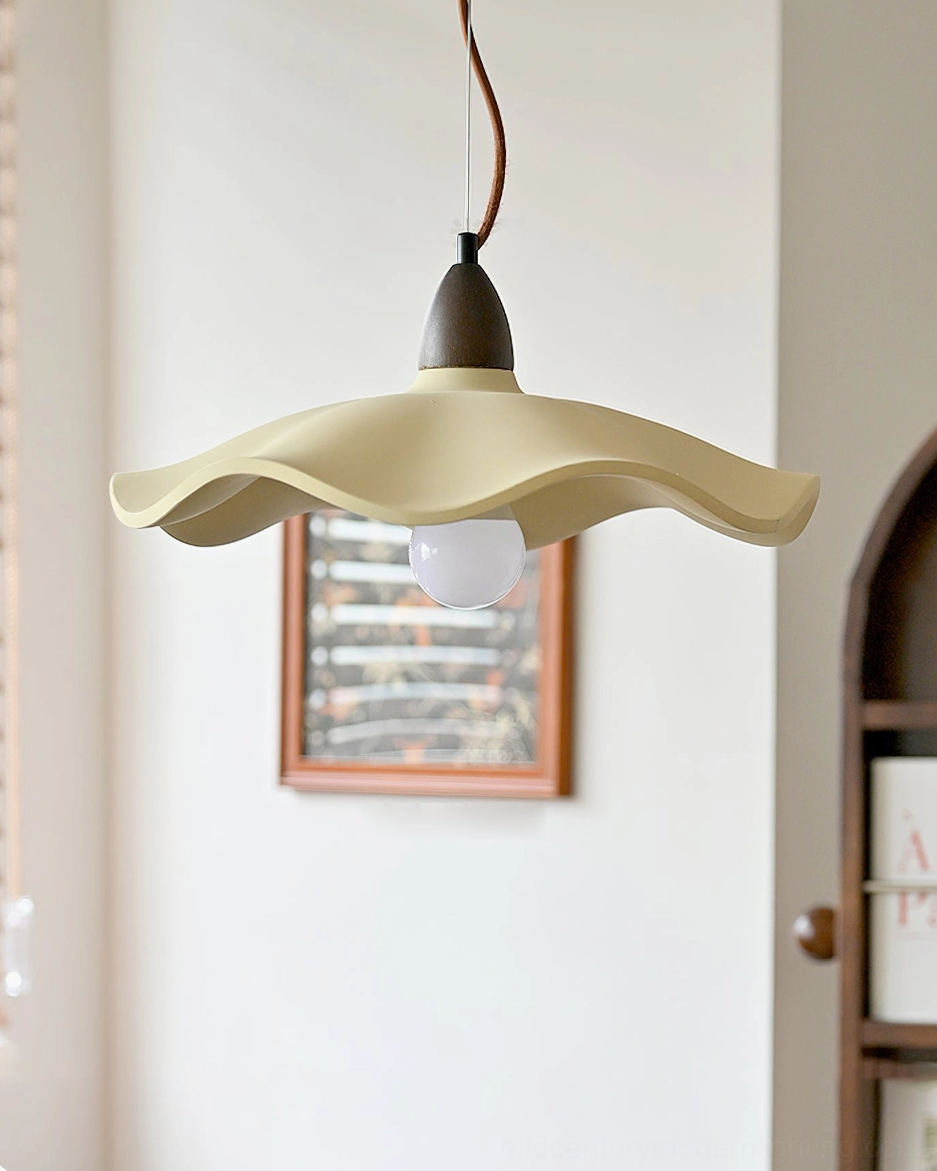 Radha wave pendant light in vintage home interior with arched wooden shelf and framed wall art