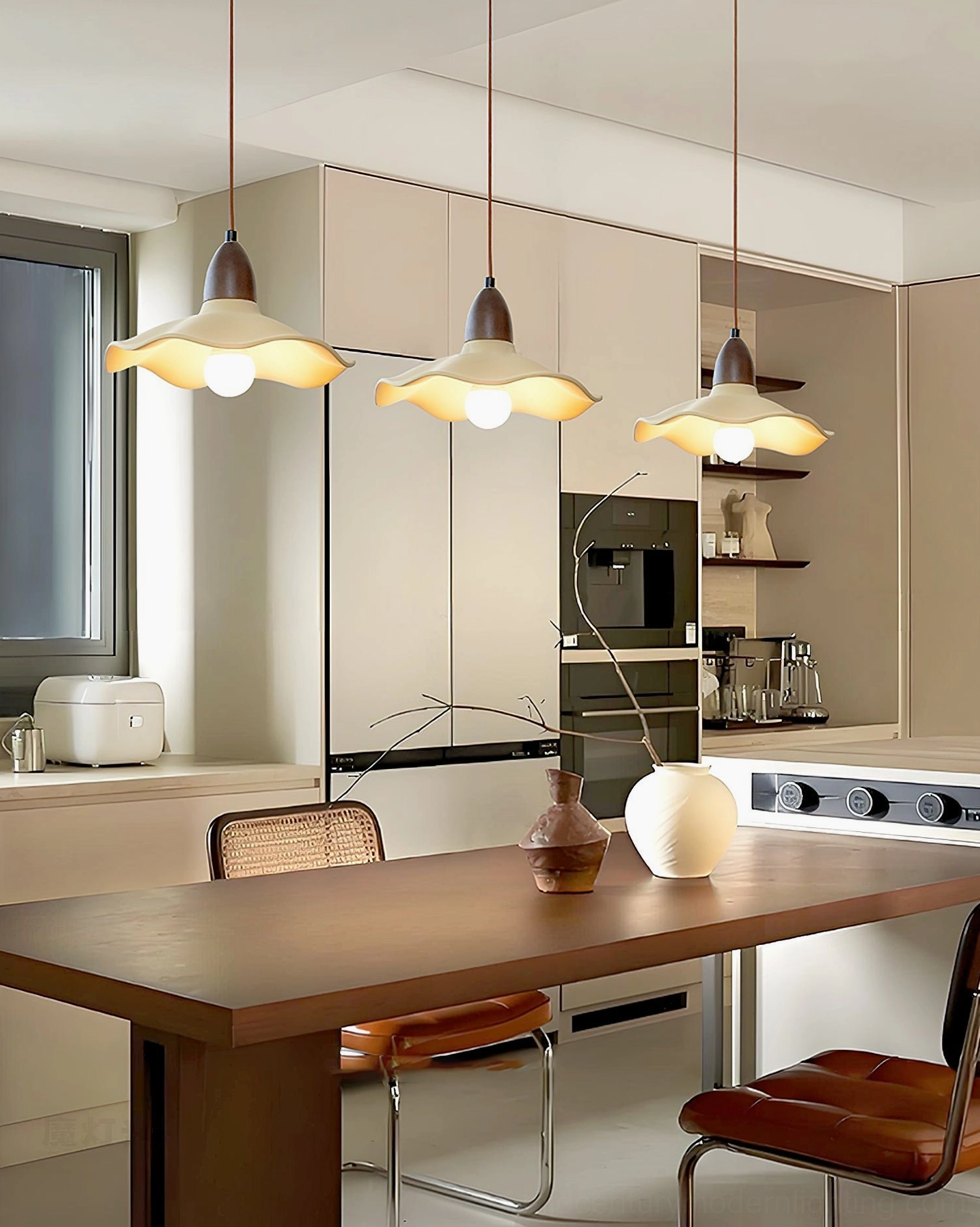 Multiple Radha wave pendants installed in modern minimalist kitchen dining space with uniform warm lighting