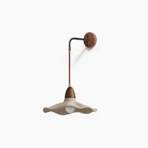 Radha concrete wall lamp with wavy shade and walnut wood arm on white studio background, showing front view