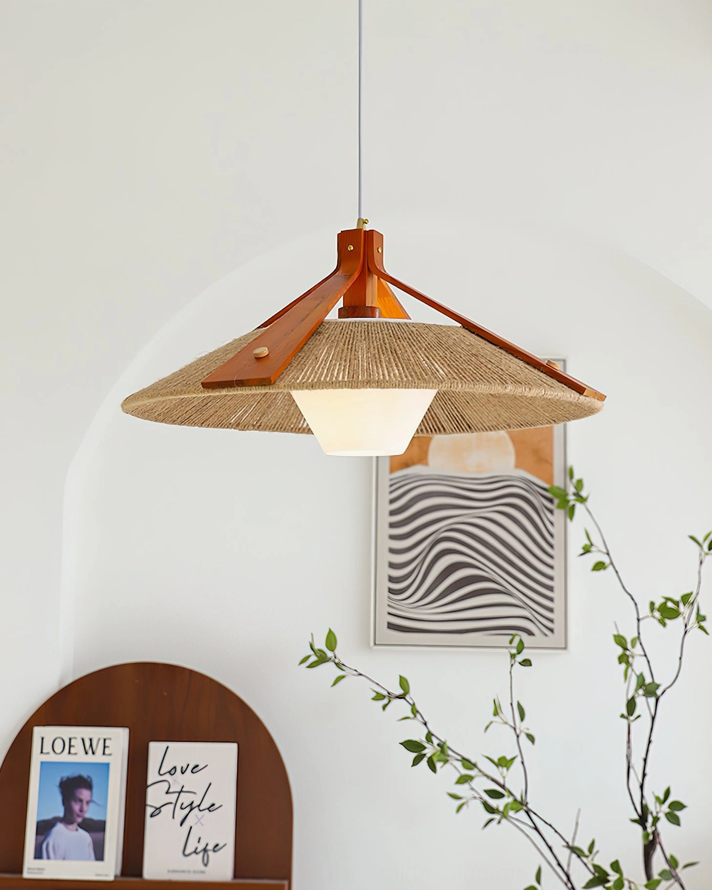 Ceiling-mounted raffia pendant light in arched architectural nook with zebra stripe artwork, frosted diffuser and rustic boho aesthetic