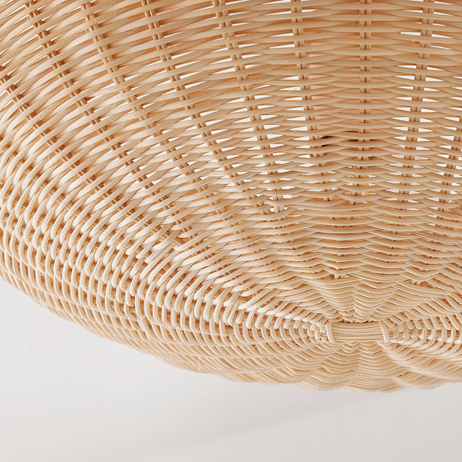 Bottom close-up of rattan lampshade showing intricate radial weave pattern and handcrafted texture details