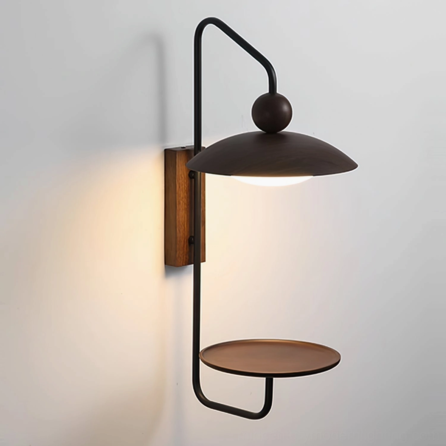 Rancho minimalist wall sconce with warm LED glow beneath disc shade, profile view demonstrating ambient lighting