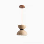 Randolf travertine pendant lamp with black metal frame, full front hanging view showing natural stone porous texture in studio lighting