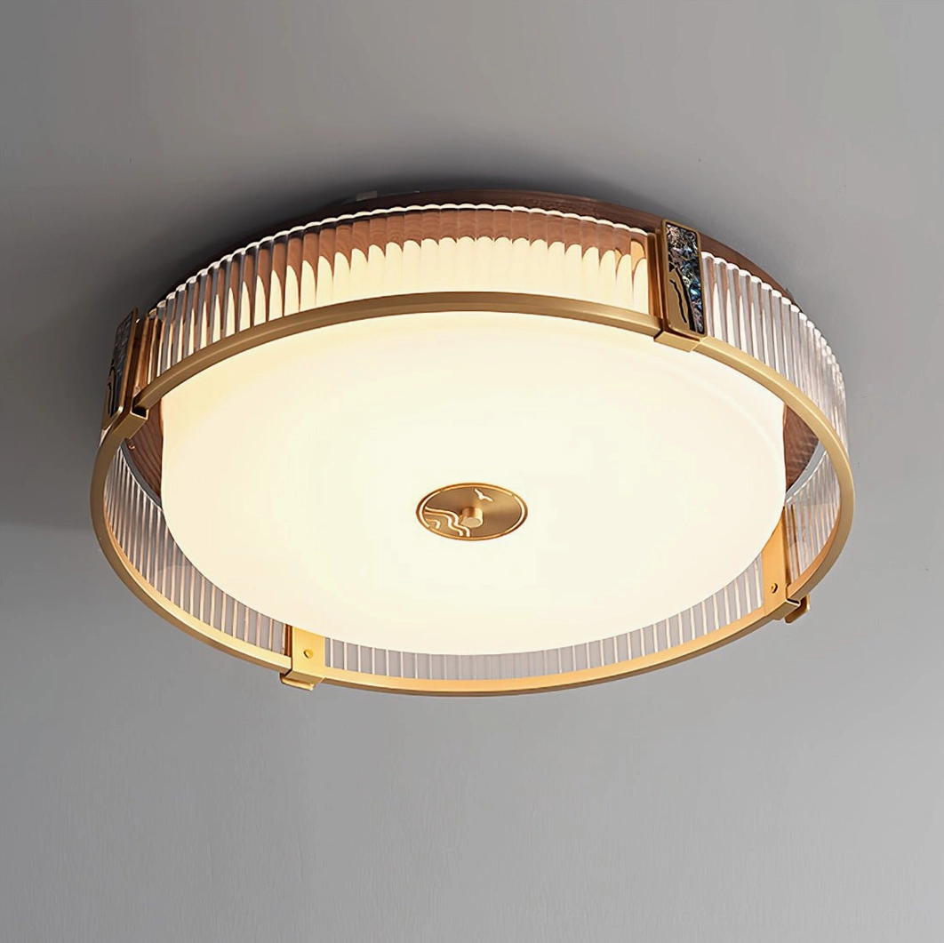 Close-up detail of Randolph ceiling lamp brass frame and ribbed diffuser with warm LED illumination