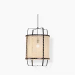 Handwoven rattan cane pendant lamp with natural bamboo weaving and black metal frame, front view on white background