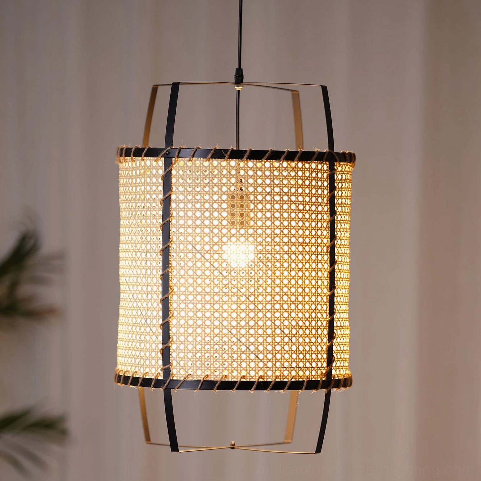 Close-up frontal view of handwoven rattan cane pendant light showing perforated mesh weaving, natural jute stitching, and metal frame details