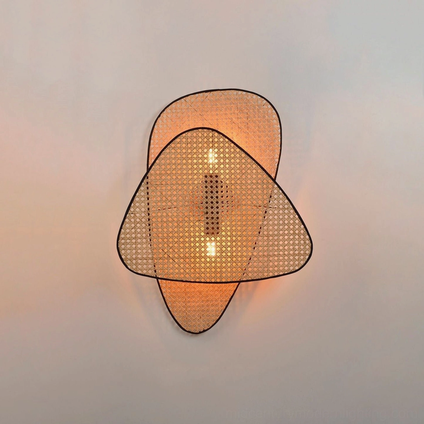 Mid-century modern woven rattan wall lamp detail shot showing bamboo cannage weave construction and craftsmanship