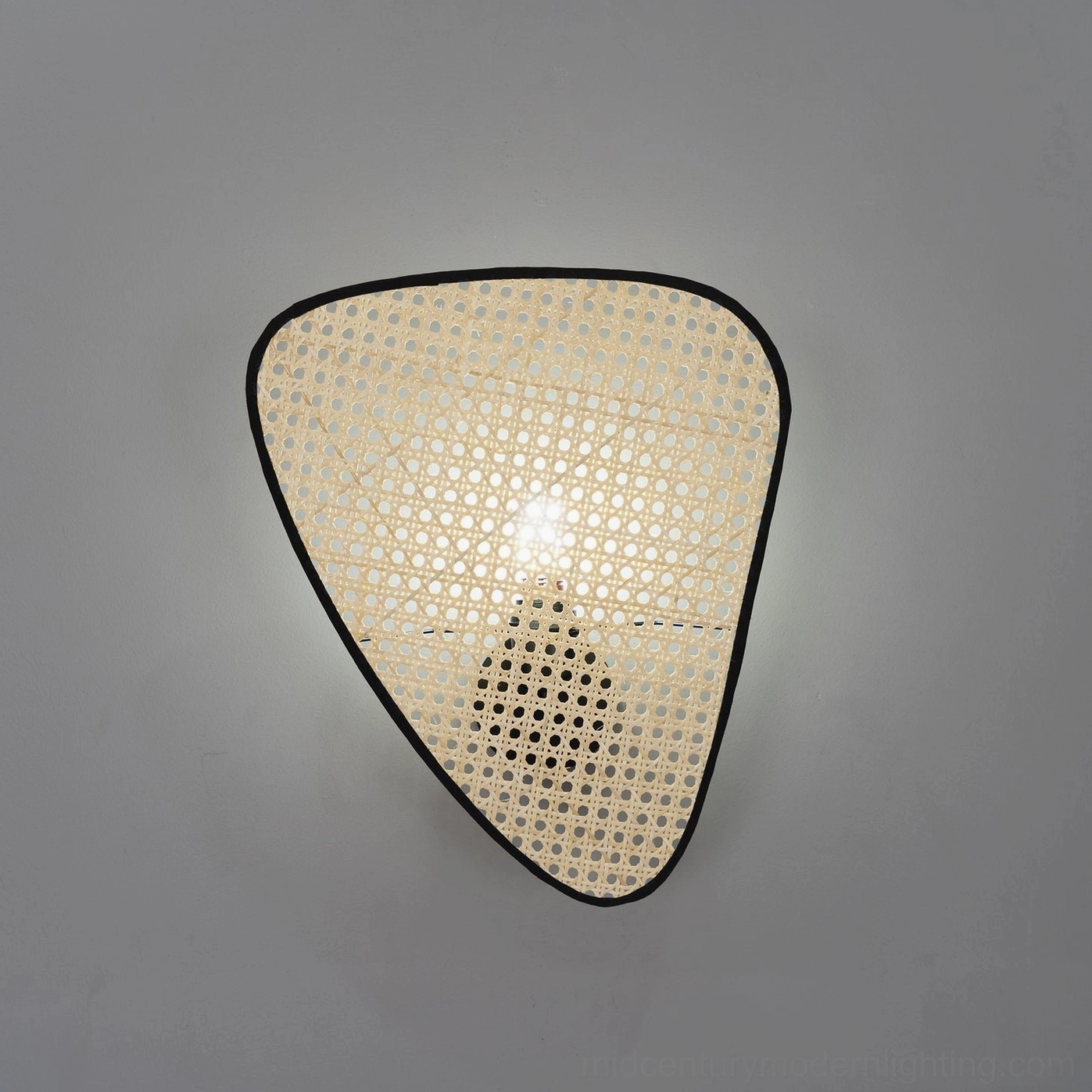 Woven rattan cannage wall lamp in Scandinavian interior design setting with blonde wood furniture and minimalist decor