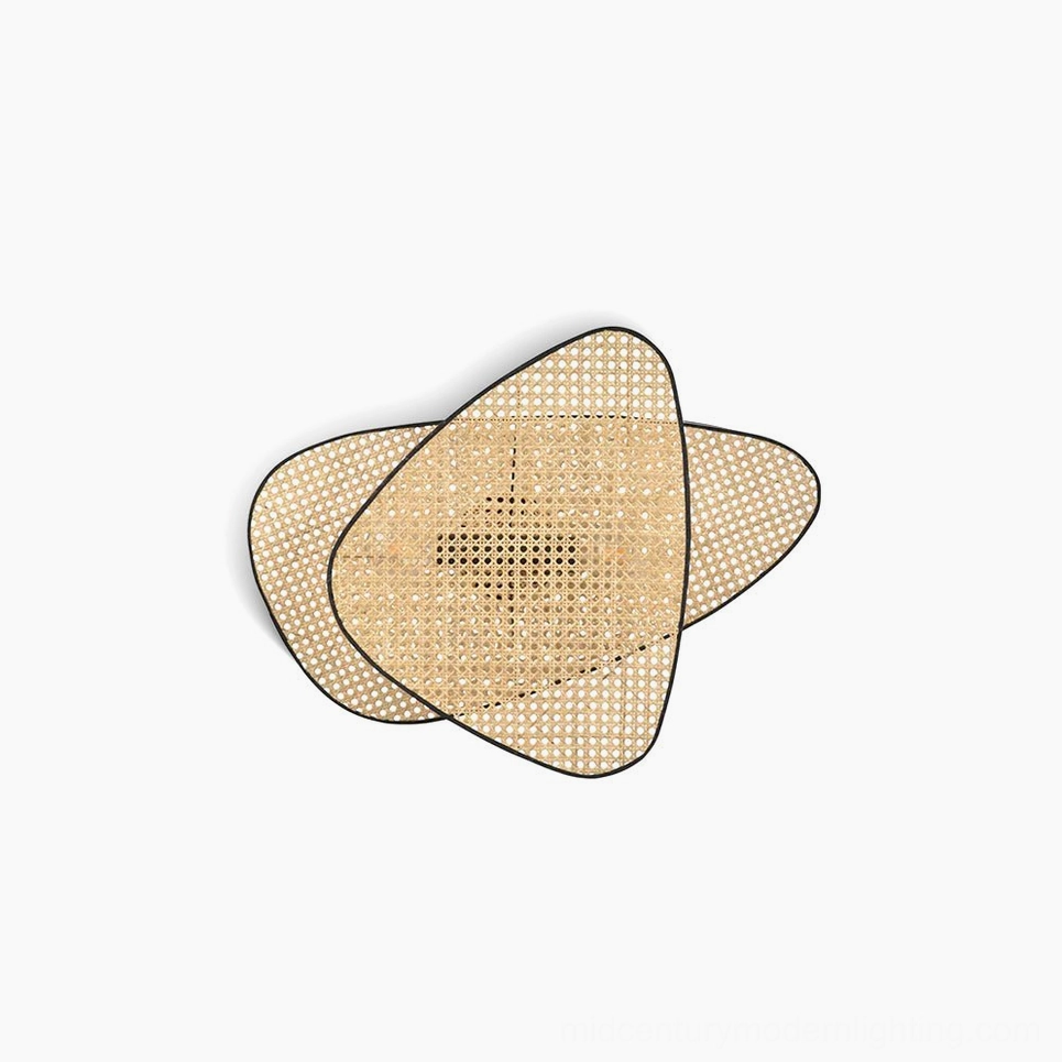 Woven rattan cannage wall lamp flat lay overhead view showing geometric triangular design with natural bamboo weave and black metal border