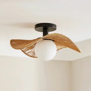 Modern rattan ceiling lamp installed in minimalist beige interior space showing wavy brown shade with black mount