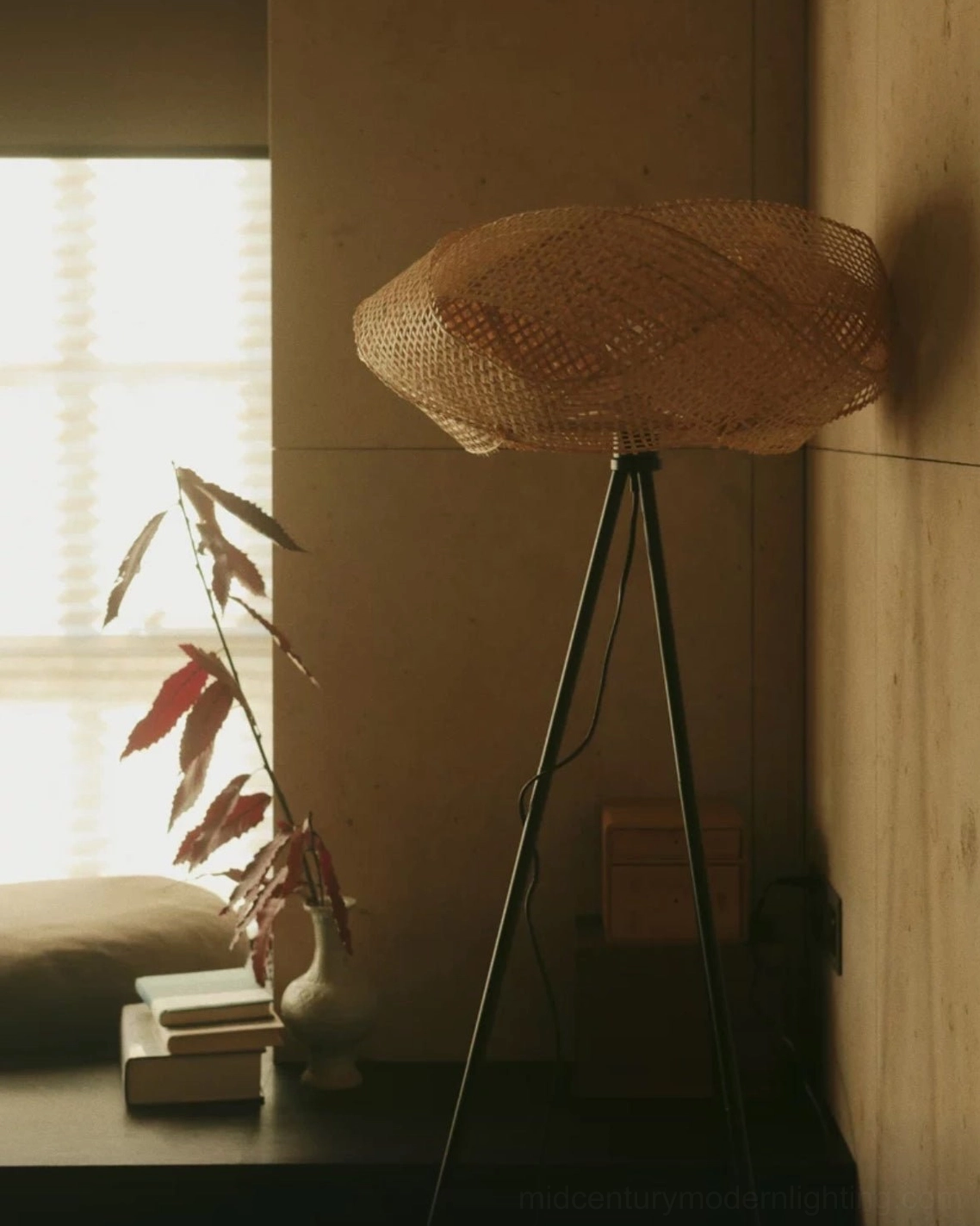 Contemporary rattan tripod floor lamp in modern home office space, ambient lighting beside workspace and creative area