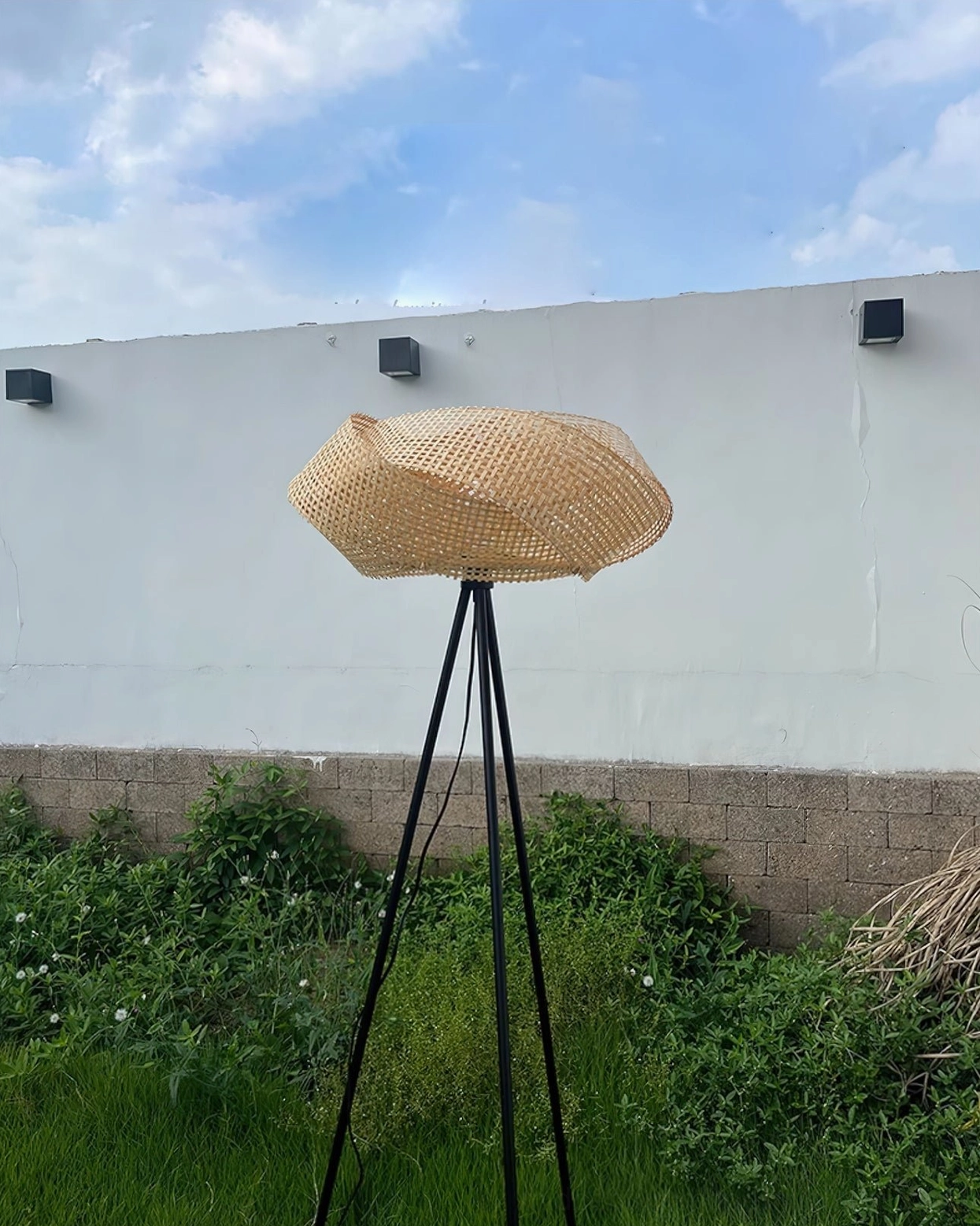 Zofia rattan floor lamp complementing industrial chic interior with exposed brick and vintage metal furnishings, contemporary lighting