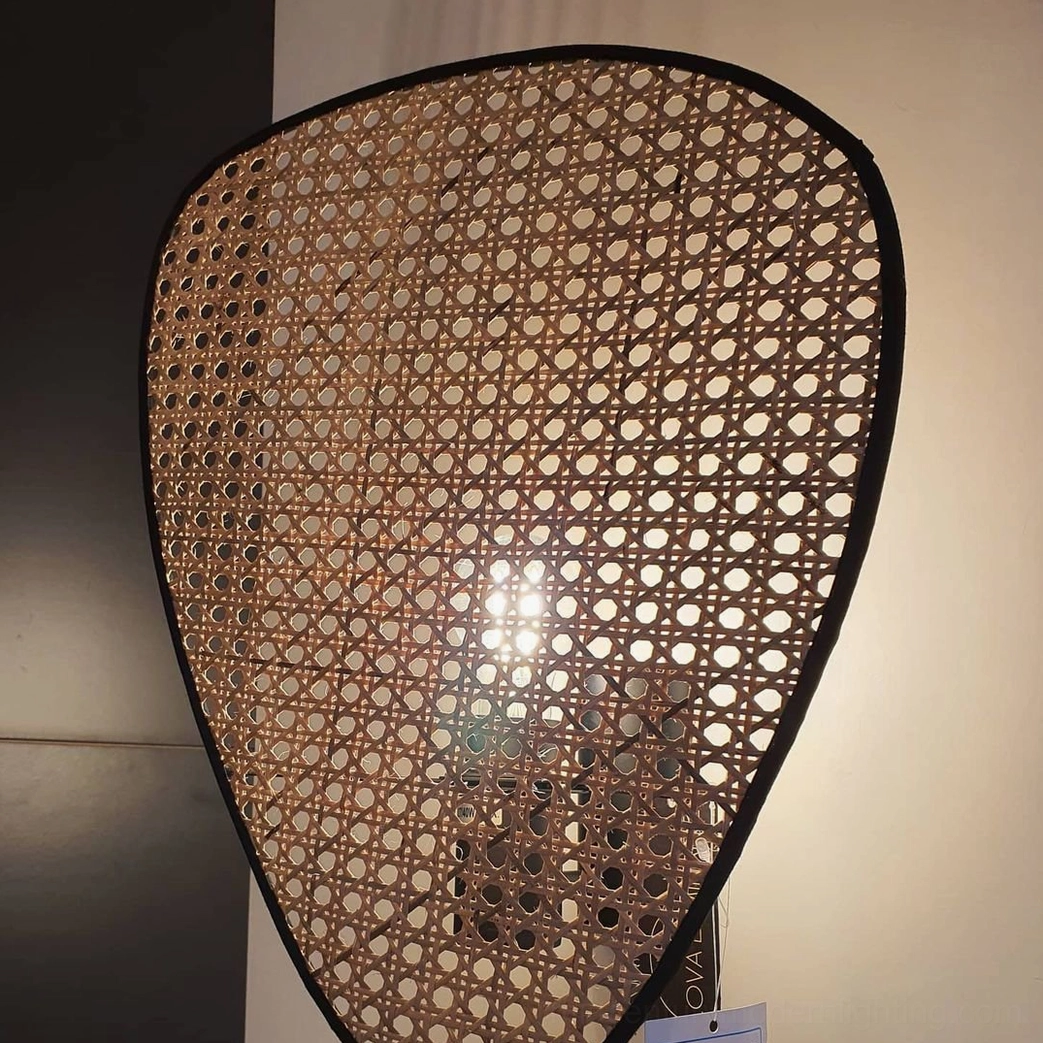 Woven rattan wall lamp with Edison bulb vintage warm glow in bohemian interior design setting