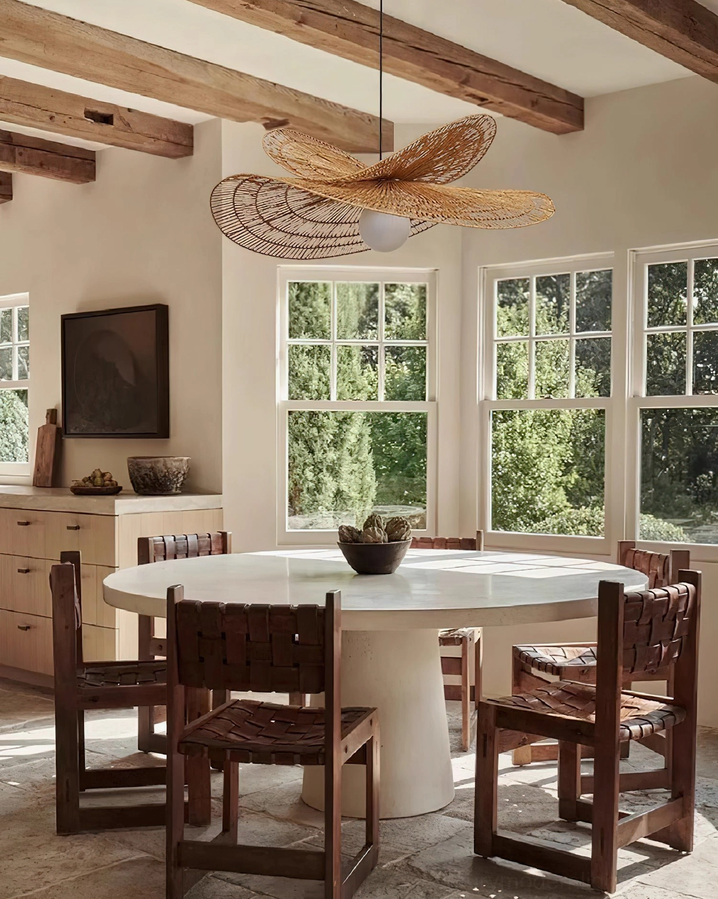 Natural rattan petal pendant light hanging in rural modern dining room with woven texture details visible