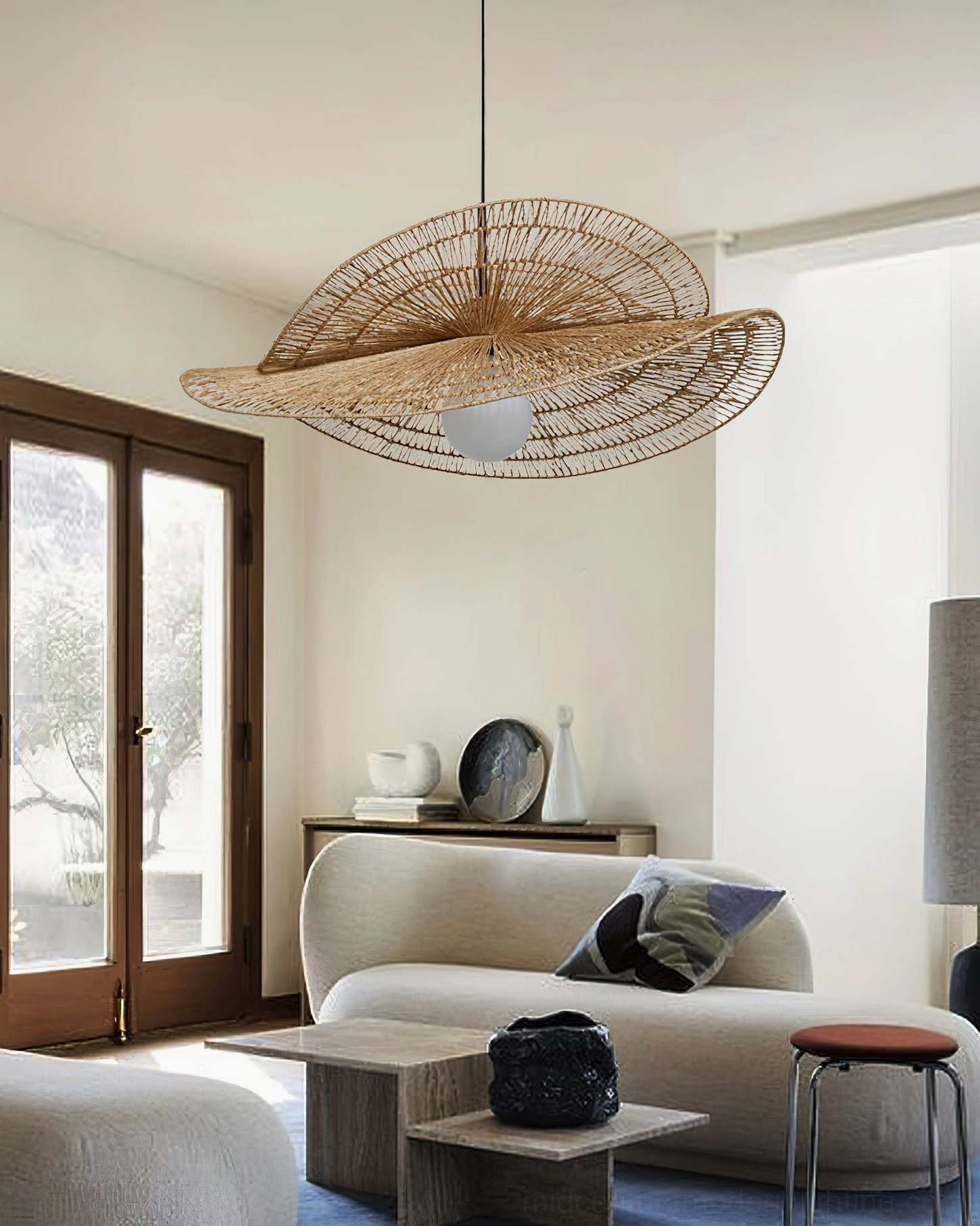 Flat disc rattan petal pendant lamp suspended in minimalist bohemian living room with natural sunlight