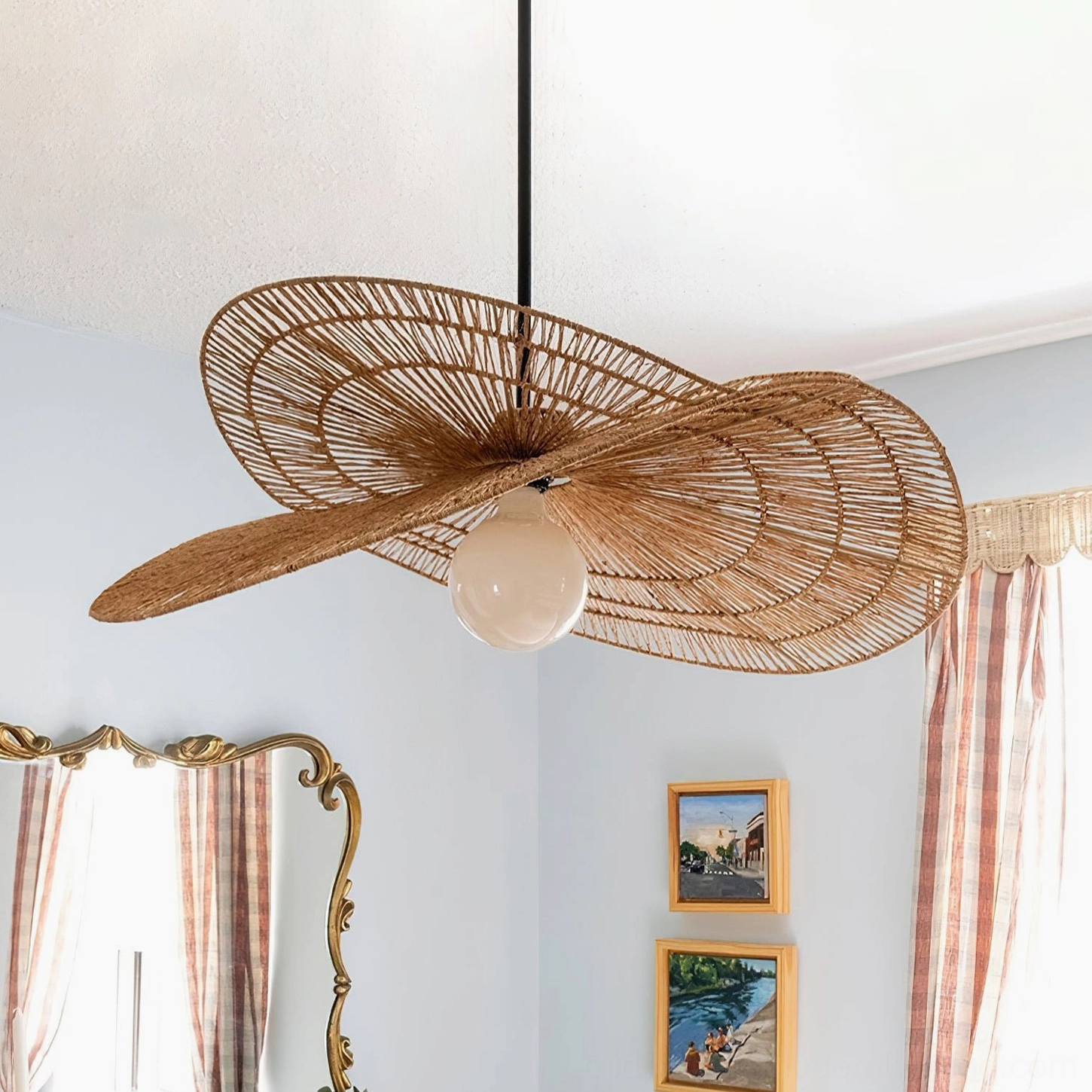 Rattan petal pendant lighting fixture installed in retro home interior with frosted glass bulb creating warm ambient glow