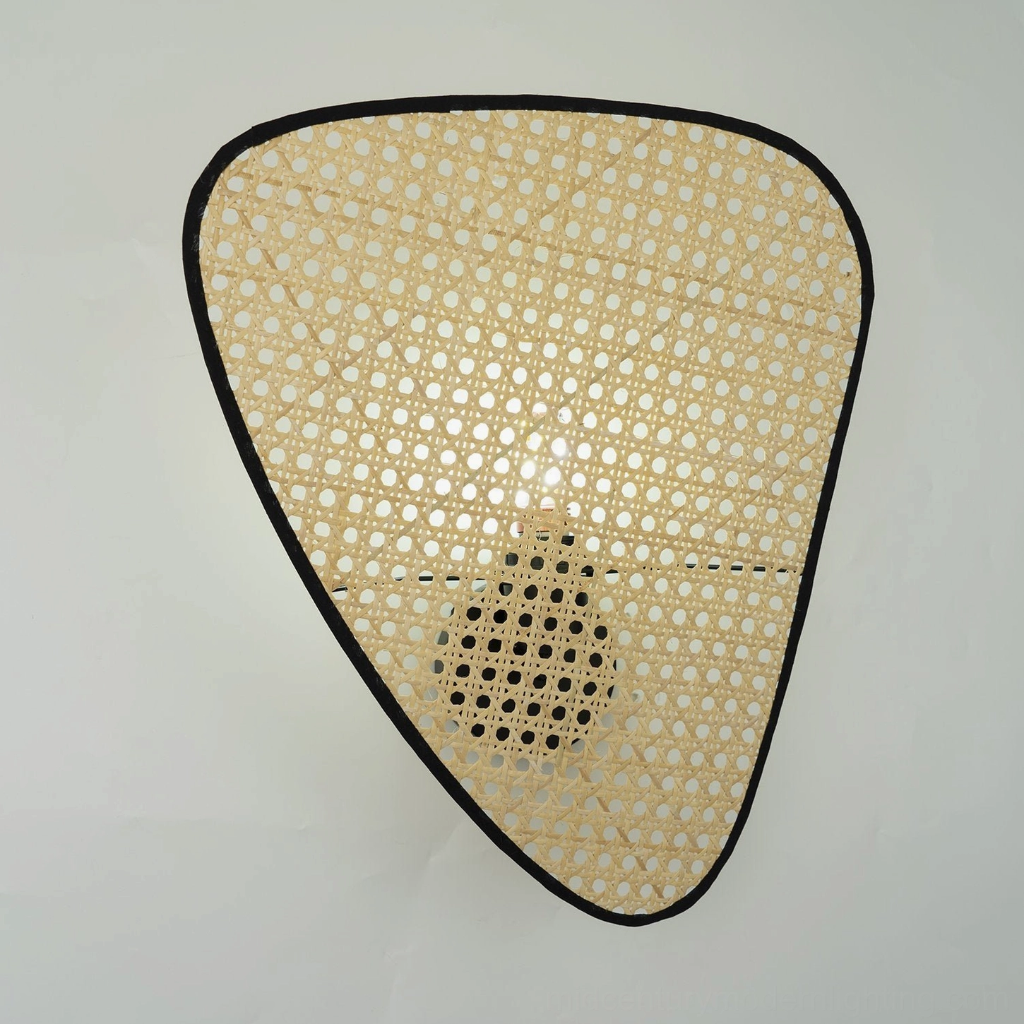 Rattan woven wall lamp hand-crafted natural materials artisanal design heritage detail