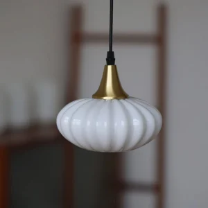 Rayburn pendant light hanging in home interior with wooden ladder and brass fixture detail, side view